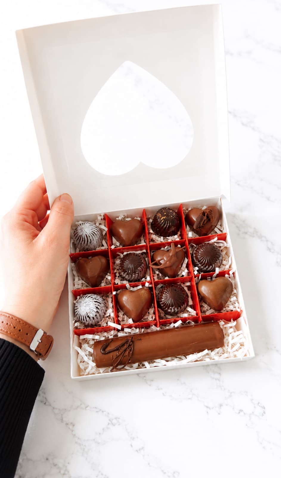 An opened gift box of handcrafted pralines